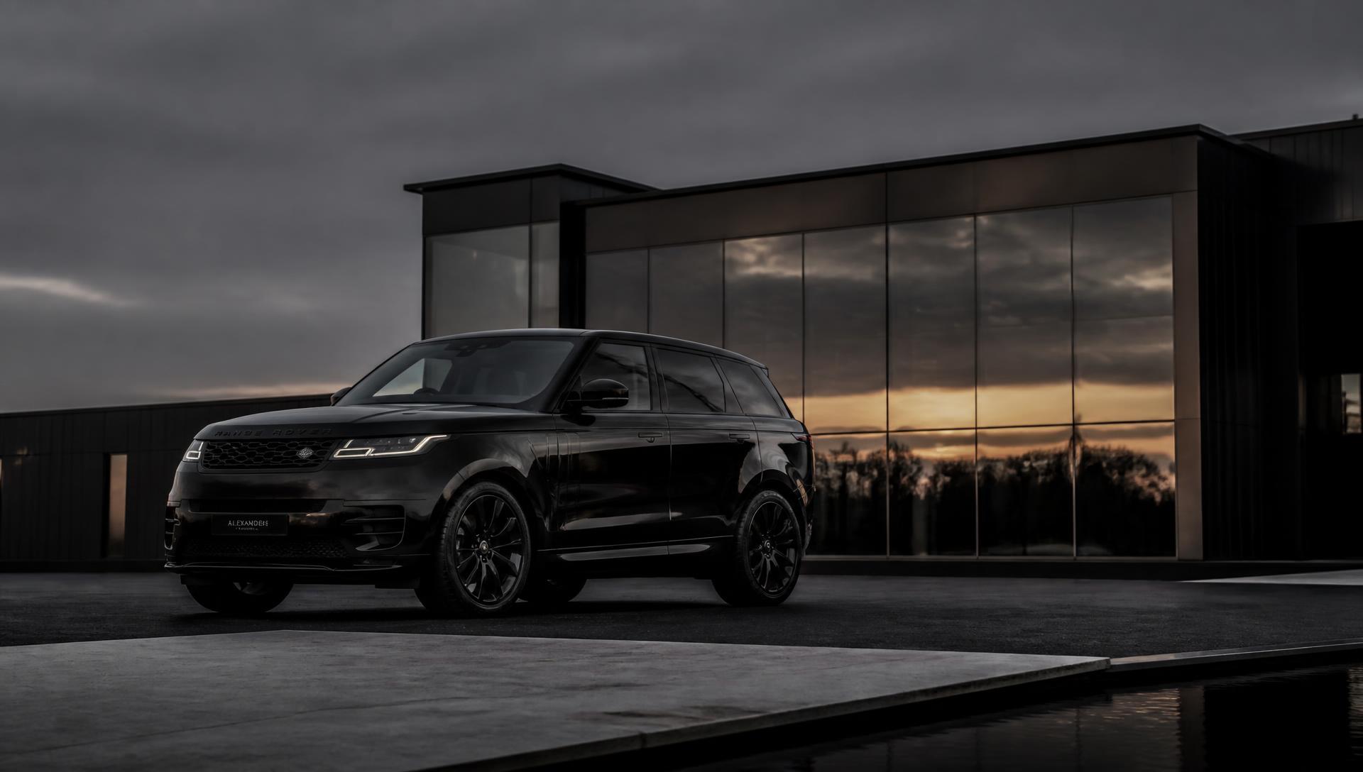 Black luxury SUV parked outside a modern building at dusk
